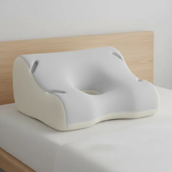Close-up of a contoured CPAP pillow highlighting its unique cut-outs and ergonomic curves for masks.