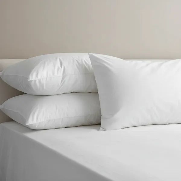 Side-by-side comparison of a natural down pillow and a synthetic down alternative pillow.